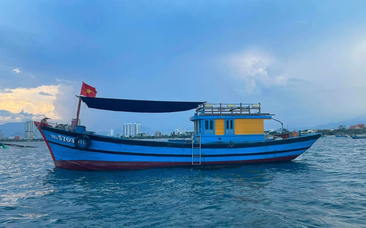 Traditional blue wooden fishing boat used for Da Nang fishing tours